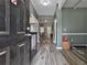Open hallway with grey vinyl floors, grey walls, and decorative lighting at 212 Long Dr, Mcdonough, GA 30253