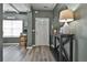 Open hallway with grey vinyl floors, grey walls, and view to front door at 212 Long Dr, Mcdonough, GA 30253