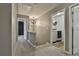 Upstairs hallway leading to laundry room with modern appliances and lighting at 212 Long Dr, Mcdonough, GA 30253