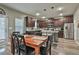 Eat-in kitchen with stainless steel appliances, dark cabinets, and an island with seating at 212 Long Dr, Mcdonough, GA 30253