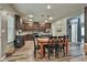 Modern kitchen with dark wood cabinets and stainless steel appliances adjacent to a dining area at 212 Long Dr, Mcdonough, GA 30253