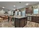 Kitchen and dining area with granite island, dark cabinetry and view to living room at 212 Long Dr, Mcdonough, GA 30253