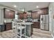Modern kitchen with granite countertops, dark cabinets, and stainless steel appliances at 212 Long Dr, Mcdonough, GA 30253
