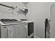 Bright laundry room with modern Samsung washer and dryer and shelving for storage at 212 Long Dr, Mcdonough, GA 30253