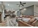 Open concept: living room with leather sectional flowing into a modern kitchen and dining area at 212 Long Dr, Mcdonough, GA 30253
