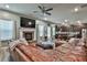 Spacious living room flows into the kitchen and dining area with a brick fireplace at 212 Long Dr, Mcdonough, GA 30253