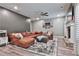 Cozy living room features a leather sectional, fireplace, and gray accent wall at 212 Long Dr, Mcdonough, GA 30253