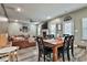 Inviting living room and dining area with a cozy leather sectional and elegant fireplace at 212 Long Dr, Mcdonough, GA 30253