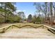 A beautiful, wooden backyard deck overlooking a spacious yard with mature trees and privacy fence at 2696 Titon Way, Lawrenceville, GA 30044