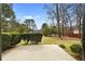 A large, concrete backyard patio offers outdoor living space surrounded by mature landscaping and a privacy fence at 2696 Titon Way, Lawrenceville, GA 30044