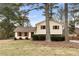 A home with a spacious lawn and red shutters, partially obscured by trees at 2696 Titon Way, Lawrenceville, GA 30044