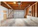 Spacious two car garage with an automatic door, natural light, and exposed ceiling beams at 2696 Titon Way, Lawrenceville, GA 30044