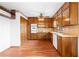Spacious kitchen with wooden cabinets, floors, and white appliances at 2696 Titon Way, Lawrenceville, GA 30044