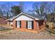 Side view of a well-kept brick home, highlighting its classic architecture and landscaping at 1119 Brittney Way, Norcross, GA 30093