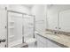 Contemporary bathroom features white cabinets, granite countertops, a shower and tile flooring at 3603 Squires Park Ln, Loganville, GA 30052