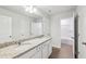 Bright bathroom featuring dual vanities, granite countertops and a shower with glass door at 3603 Squires Park Ln, Loganville, GA 30052