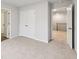 Carpeted bedroom featuring neutral color scheme with views into adjacent spaces through doors at 3603 Squires Park Ln, Loganville, GA 30052