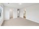 Bedroom featuring neutral carpet, paint and trim with views to the stairway, bedroom and closet at 3603 Squires Park Ln, Loganville, GA 30052