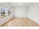 Bright, empty bedroom featuring wood-look floors and large windows providing lots of natural light at 3603 Squires Park Ln, Loganville, GA 30052