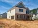 Exterior view of a new home featuring brick accents, white siding, and a covered front porch at 3603 Squires Park Ln, Loganville, GA 30052