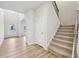 Bright foyer featuring wood-look floors, a carpeted staircase, and a view into the living room at 3603 Squires Park Ln, Loganville, GA 30052