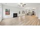 Open-concept living room with hardwood floors and fireplace at 3603 Squires Park Ln, Loganville, GA 30052