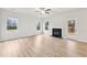 Spacious living room featuring wood-look floors, a fireplace, and two windows providing lots of natural light at 3603 Squires Park Ln, Loganville, GA 30052