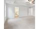 Spacious bedroom features plush carpet, tray ceiling, and access to the bathroom at 3603 Squires Park Ln, Loganville, GA 30052