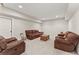 Comfortable basement sitting area with plush sofas and a rustic coffee table, perfect for relaxing at 6625 Baywood Run, Cumming, GA 30041