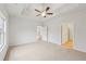 A carpeted bedroom featuring a ceiling fan, bright window and two entryways at 1461 Stephens View Dr, Loganville, GA 30052