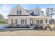 Charming single-Gathering home features a welcoming front porch, gray siding, and beautifully trimmed windows at 1461 Stephens View Dr, Loganville, GA 30052
