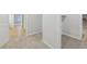 View of a carpeted hallway featuring tile and vinyl flooring in connecting rooms at 1461 Stephens View Dr, Loganville, GA 30052