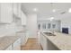 Bright kitchen featuring granite countertops, an island sink and hardwood style floors at 1461 Stephens View Dr, Loganville, GA 30052