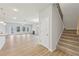 Bright, open-concept living room with luxury vinyl flooring, fireplace, and staircase at 1461 Stephens View Dr, Loganville, GA 30052