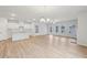 Open-concept living space with kitchen, with wood floors and ample natural light at 1461 Stephens View Dr, Loganville, GA 30052