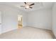 Large primary bedroom with an ensuite bathroom and tray ceiling with fan at 1461 Stephens View Dr, Loganville, GA 30052