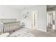 Bright Bedroom with crib, round rug, and neutral color palette at 5378 Pebblebrook Se Ln, Mableton, GA 30126