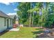 Private backyard featuring a patio, new grass and mature trees at 6304 Marbut Farms Ln, Lithonia, GA 30058