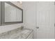 This bathroom features granite counters, white cabinets, and a large mirror at 6304 Marbut Farms Ln, Lithonia, GA 30058