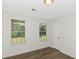 Cozy bedroom with two bright windows and hardwood floors at 6304 Marbut Farms Ln, Lithonia, GA 30058