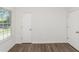Bedroom with hardwood floors, a window with blinds and two doors at 6304 Marbut Farms Ln, Lithonia, GA 30058
