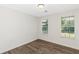 Bright bedroom with hardwood floors and two windows looking onto lawn at 6304 Marbut Farms Ln, Lithonia, GA 30058