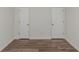 Bedroom with hardwood floors and two doors at 6304 Marbut Farms Ln, Lithonia, GA 30058