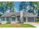 Charming single-Gathering home featuring a well-maintained lawn and attached garage at 6304 Marbut Farms Ln, Lithonia, GA 30058
