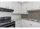 Renovated kitchen boasting granite countertops and updated stainless steel appliances at 6304 Marbut Farms Ln, Lithonia, GA 30058