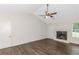 Spacious living room featuring a fireplace and a modern ceiling fan at 6304 Marbut Farms Ln, Lithonia, GA 30058