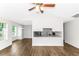 Bright living room with new laminate flooring and contemporary ceiling fan at 6304 Marbut Farms Ln, Lithonia, GA 30058