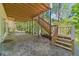 View of back patio featuring stairs to upper deck and wooded surroundings at 776 Myerston Ct, Lawrenceville, GA 30044