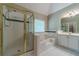 A remodeled bathroom featuring a shower, jacuzzi tub, double sinks, and vanity with white cabinets at 776 Myerston Ct, Lawrenceville, GA 30044