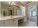 A bright bathroom featuring double sinks and vanity with an entrance to the bedroom at 776 Myerston Ct, Lawrenceville, GA 30044